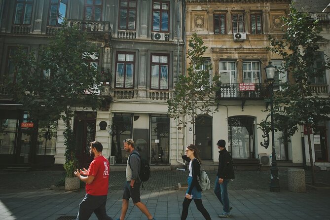 Discover Bucharest: Private Highlights and Traditional Food Tour - Revolution Square context, plus the statue detail that sticks