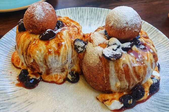 Sweet Delights History and Desserts Walking Tour in Bucharest - Stop 5: Old Town Finale with Papanasi, the Romanian Doughnut Moment