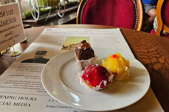 Sweet Delights History and Desserts Walking Tour in Bucharest - Stop 2: Revolution Square, Communist Life and a Famous Chocolate Bite